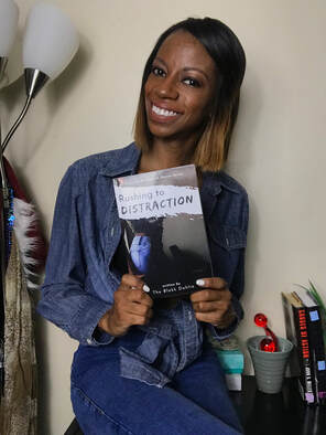 Author, The Blakk Dahlia, posing with her book, Rushing with Distraction