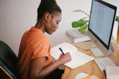 black woman writing in journal, journaling, african american woman